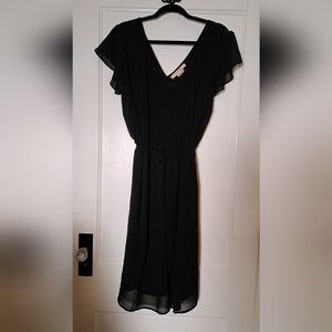 Flutter sleeve black chiffon lined dress with pin tucked front detail